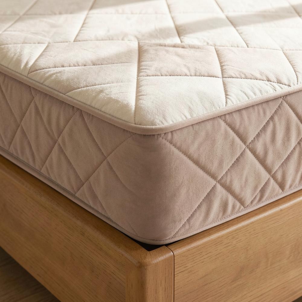 Quilted taupe waterproof fitted sheet on a mattress corner